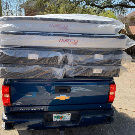 Two mattress set in pickup truck 